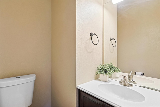 half bath with vanity and toilet