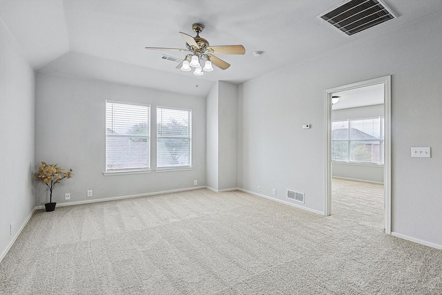 empty room with light colored carpet, visible vents, and baseboards