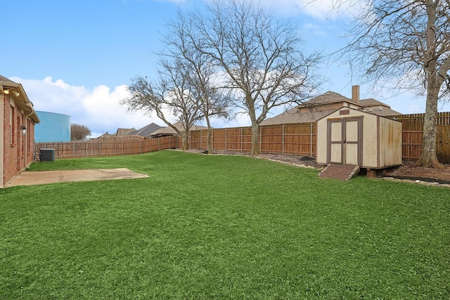 view of yard with a patio, a storage unit, central AC, a fenced backyard, and an outdoor structure