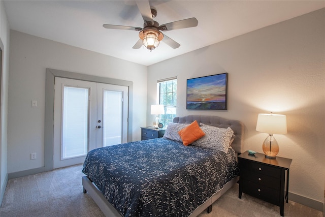 carpeted bedroom with a ceiling fan, french doors, and baseboards