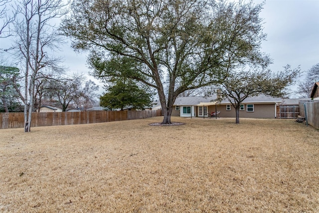 view of yard with a fenced backyard