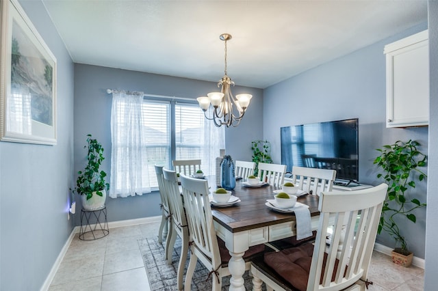 dining room featuring light tile patterned floors, baseboards, and an inviting chandelier