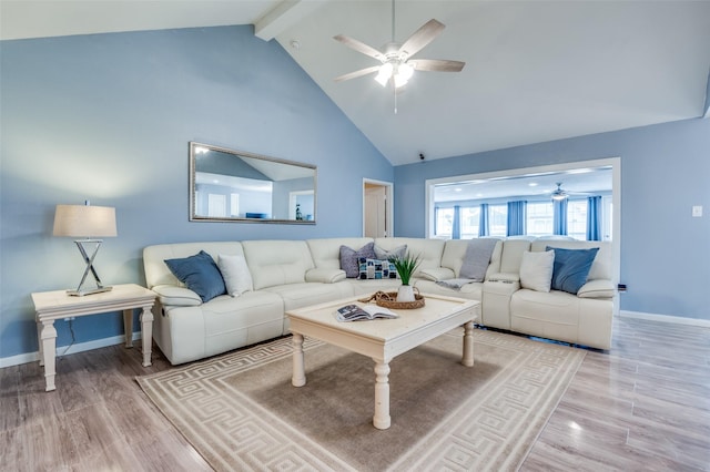 living area with high vaulted ceiling, wood finished floors, beam ceiling, and a ceiling fan