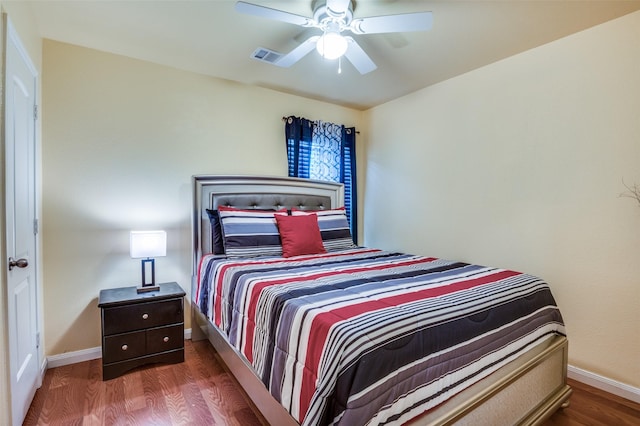 bedroom with visible vents, ceiling fan, baseboards, and wood finished floors