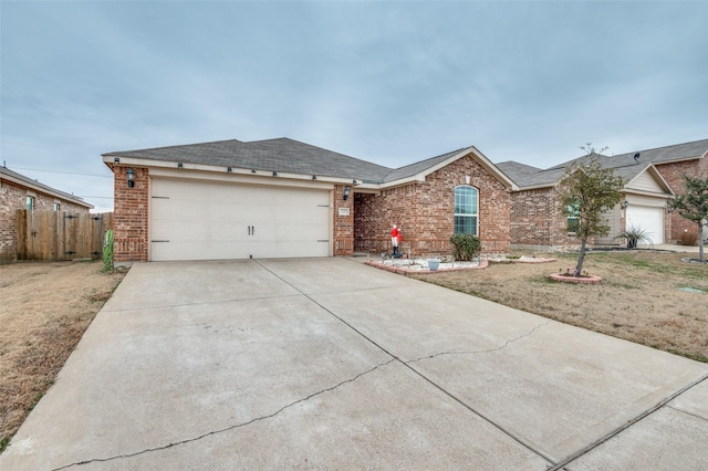 ranch-style home featuring a garage, concrete driveway, brick siding, and fence