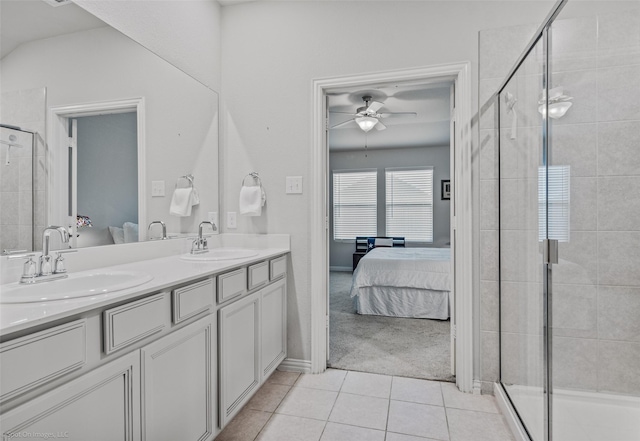 ensuite bathroom featuring a sink, tile patterned flooring, and connected bathroom