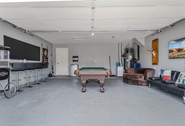 game room with a garage, heat pump water heater, speckled floor, and pool table