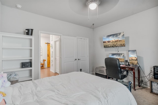 carpeted bedroom with ceiling fan and baseboards