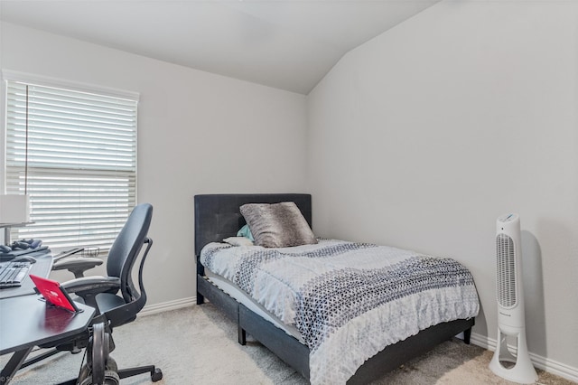 bedroom featuring baseboards, vaulted ceiling, and light colored carpet