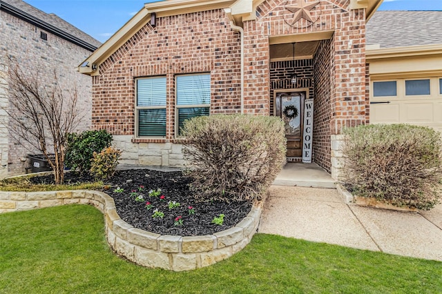 property entrance featuring stone siding, brick siding, and an attached garage