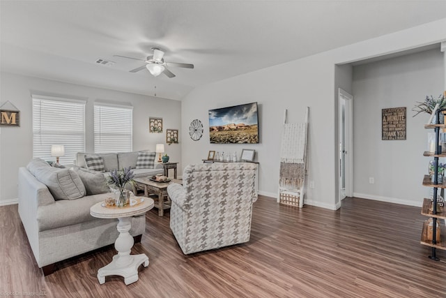 living area featuring baseboards, visible vents, a ceiling fan, and wood finished floors