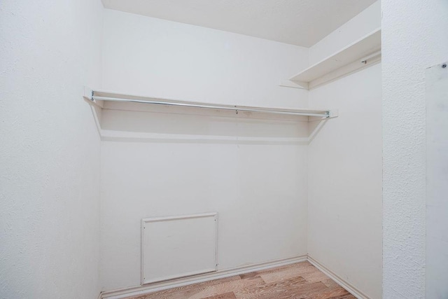 spacious closet with light wood finished floors