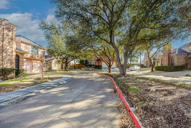 view of street with sidewalks, a residential view, and curbs