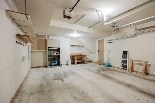 garage with baseboards and a garage door opener