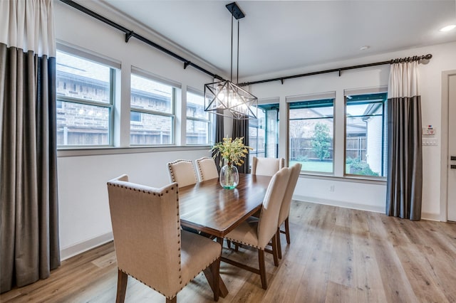 dining room featuring a wealth of natural light, light wood-style flooring, and baseboards