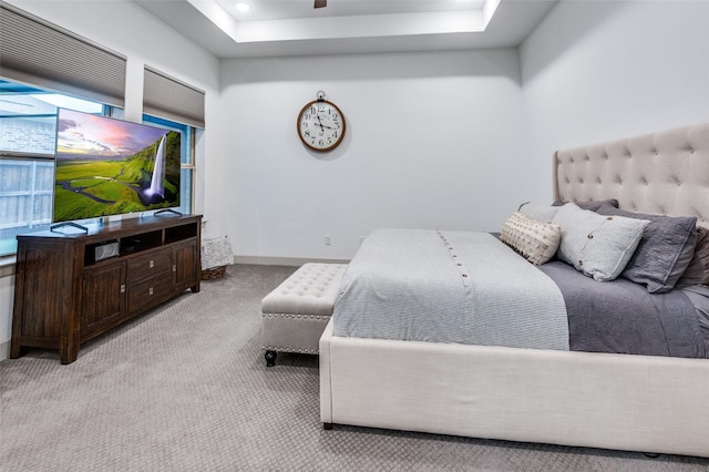 bedroom with recessed lighting, a raised ceiling, light colored carpet, and baseboards