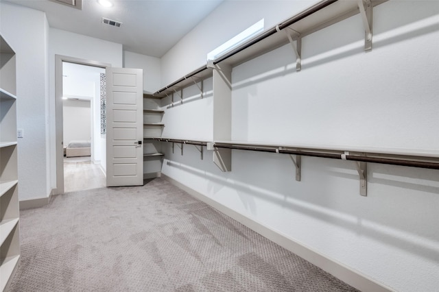 spacious closet with light carpet and visible vents