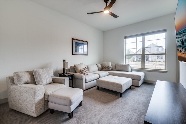 carpeted living room with ceiling fan and baseboards