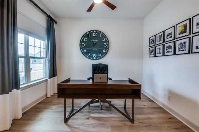 home office featuring ceiling fan, wood finished floors, and baseboards