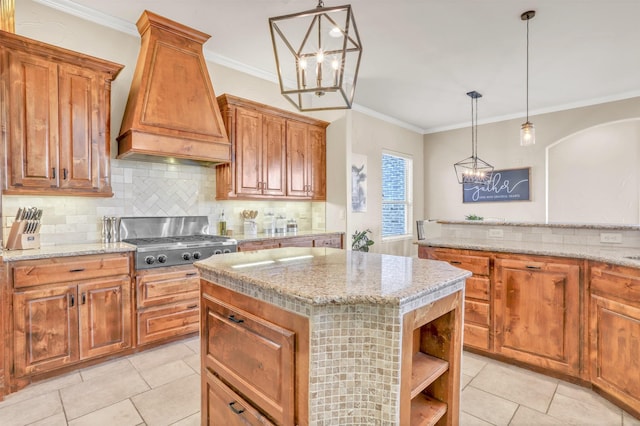 kitchen with a center island, crown molding, stainless steel gas cooktop, custom exhaust hood, and backsplash