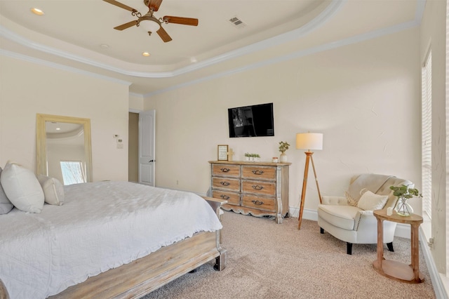 carpeted bedroom with a tray ceiling, crown molding, recessed lighting, visible vents, and a ceiling fan