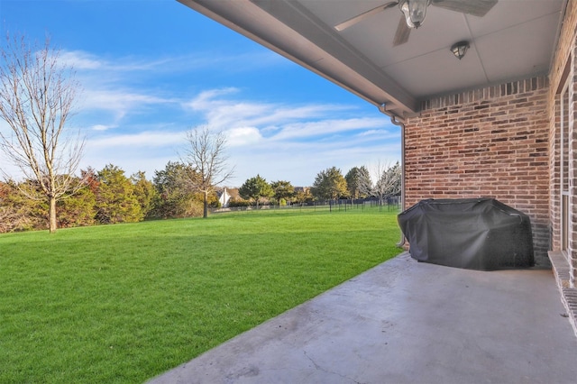 view of yard featuring ceiling fan and a patio