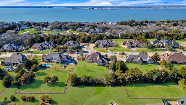 drone / aerial view featuring a residential view and a water view