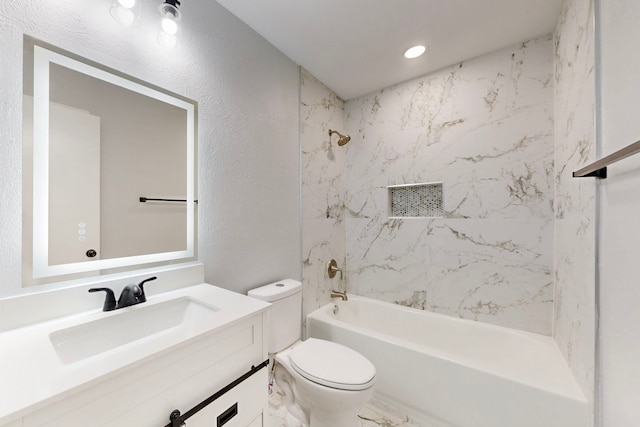 bathroom with a textured wall, toilet, marble finish floor, tub / shower combination, and vanity