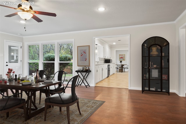 dining area with ceiling fan, crown molding, baseboards, and wood finished floors