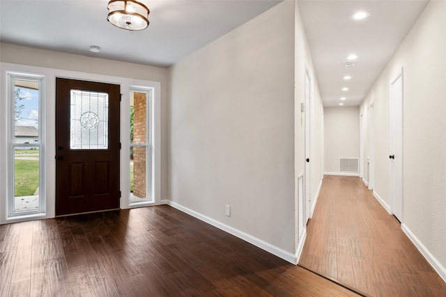 foyer with plenty of natural light, wood finished floors, and visible vents