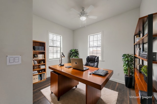 office area featuring ceiling fan, baseboards, dark wood finished floors, and a healthy amount of sunlight