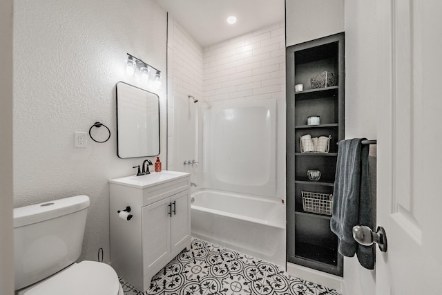 full bathroom featuring a textured wall, tile patterned flooring, toilet, bathing tub / shower combination, and vanity
