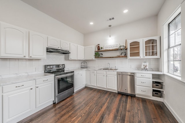 kitchen with white cabinets, appliances with stainless steel finishes, light countertops, and glass insert cabinets