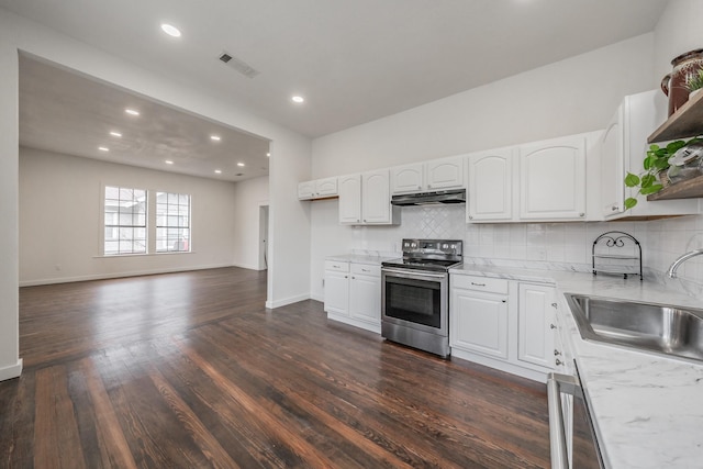 kitchen with a sink, white cabinets, open floor plan, appliances with stainless steel finishes, and open shelves