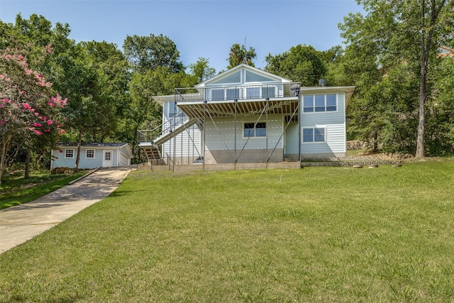 view of front of property with a deck, a front yard, stairway, and an outbuilding