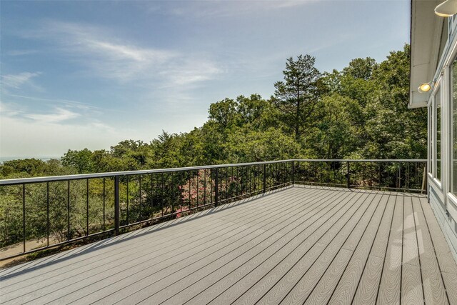 wooden deck featuring a grill