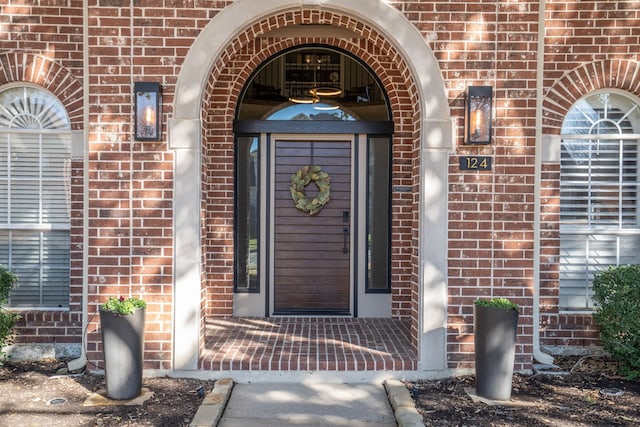 doorway to property with brick siding