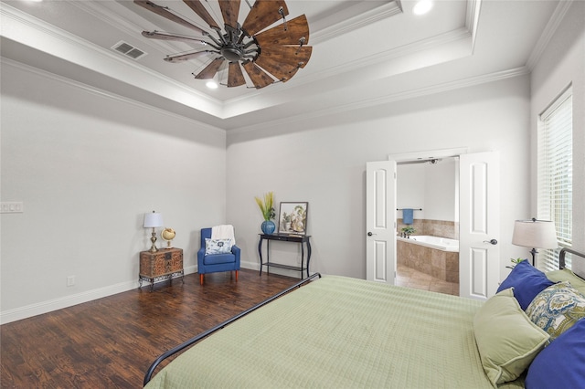 bedroom featuring baseboards, visible vents, ornamental molding, wood finished floors, and a tray ceiling