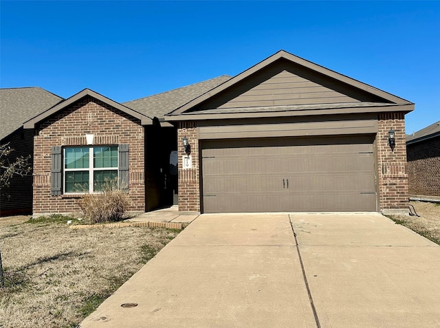 ranch-style home featuring driveway, brick siding, an attached garage, and a shingled roof