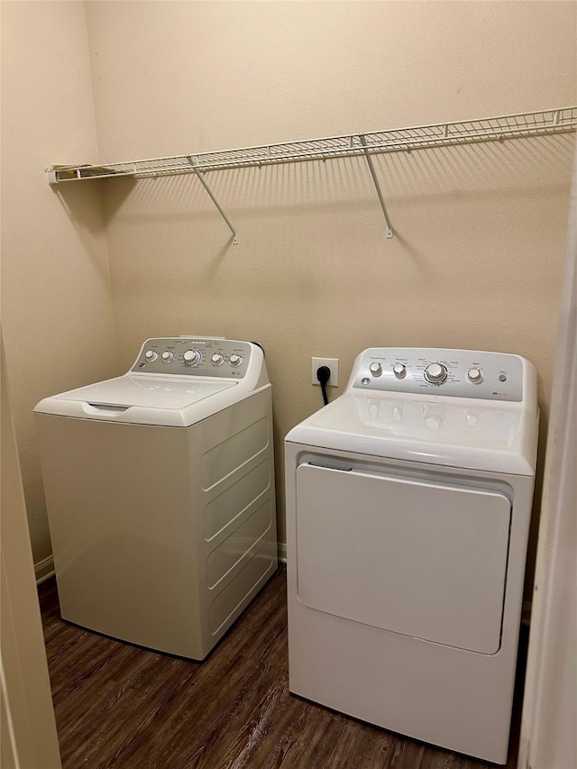 laundry area with laundry area, dark wood-style flooring, and washer and dryer