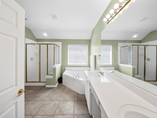 full bathroom featuring vaulted ceiling, a stall shower, a sink, and tile patterned floors