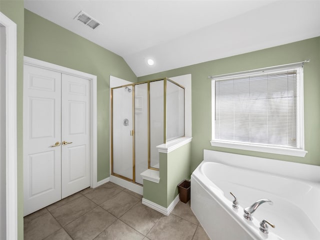 bathroom featuring tile patterned flooring, visible vents, vaulted ceiling, a shower stall, and a bath