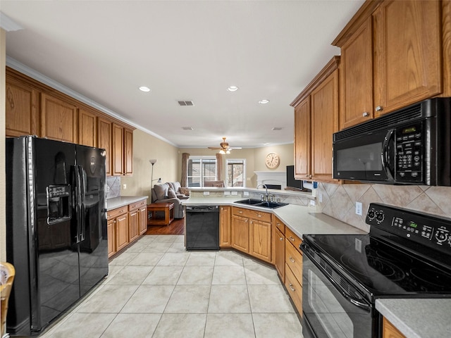 kitchen featuring light tile patterned flooring, a sink, visible vents, light countertops, and black appliances