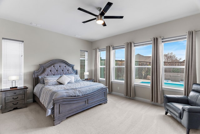 bedroom featuring light carpet, visible vents, baseboards, and a ceiling fan