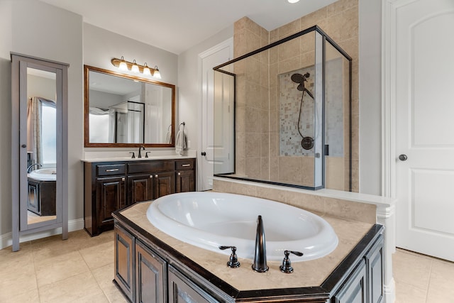 full bathroom with a stall shower, a garden tub, vanity, and tile patterned floors