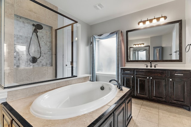 full bath with a stall shower, visible vents, tile patterned floors, a garden tub, and vanity