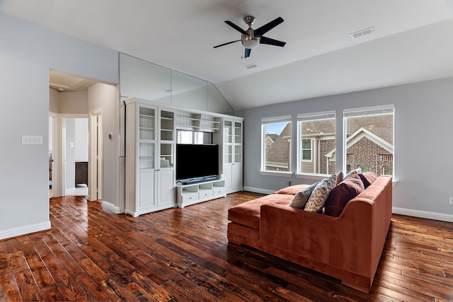 living room featuring baseboards, visible vents, ceiling fan, dark wood-style flooring, and vaulted ceiling