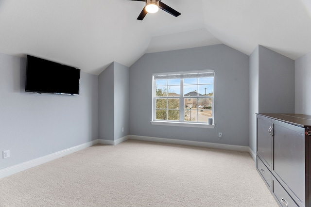 additional living space with lofted ceiling, baseboards, and light colored carpet