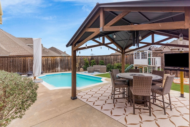 view of pool with a fenced backyard, an outdoor structure, an outdoor living space, an outdoor bar, and a shed