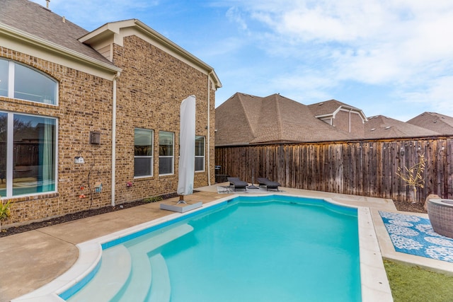 view of pool with a fenced backyard, a fenced in pool, and a patio